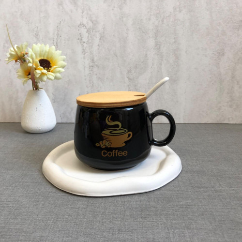 Black mug with wooden lid and spoon