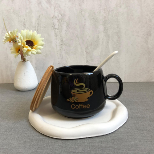 Black mug with wooden lid and spoon