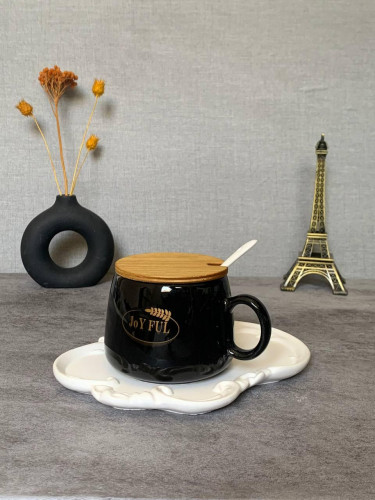 Black mug with wooden lid and spoon