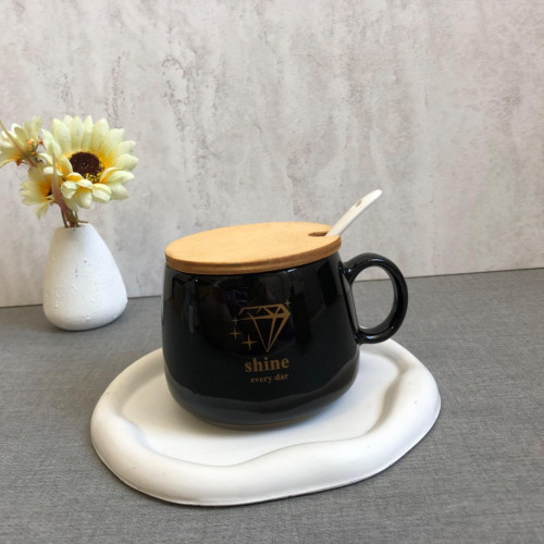 Black mug with wooden lid and spoon