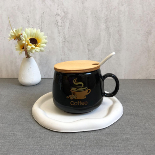 Black mug with wooden lid and spoon